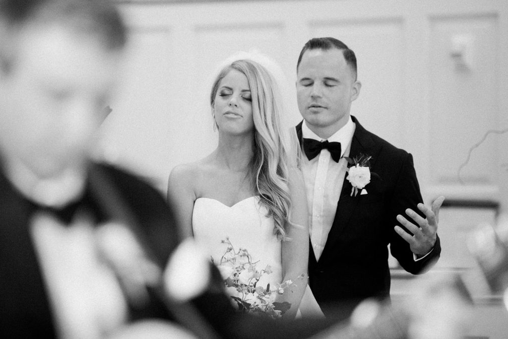 Bride and groom praying during wedding ceremony in Fox Chapel Pennsylvania