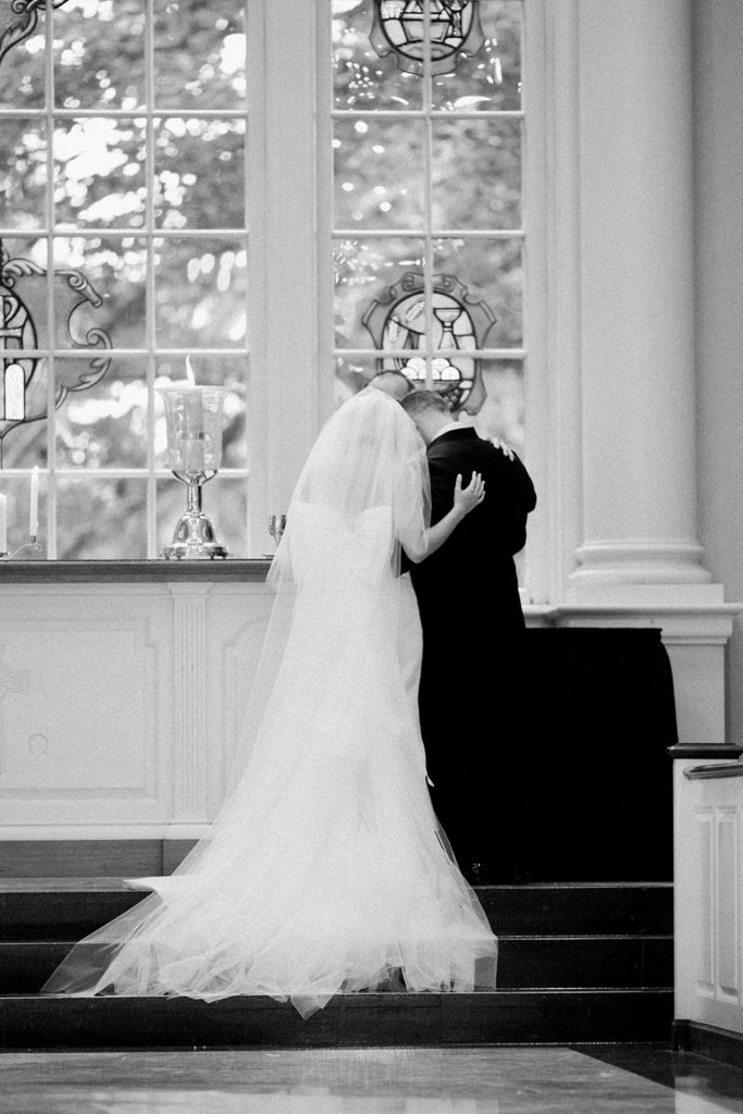 Bride and groom lighting unity candle during Fox Chapel wedding ceremony