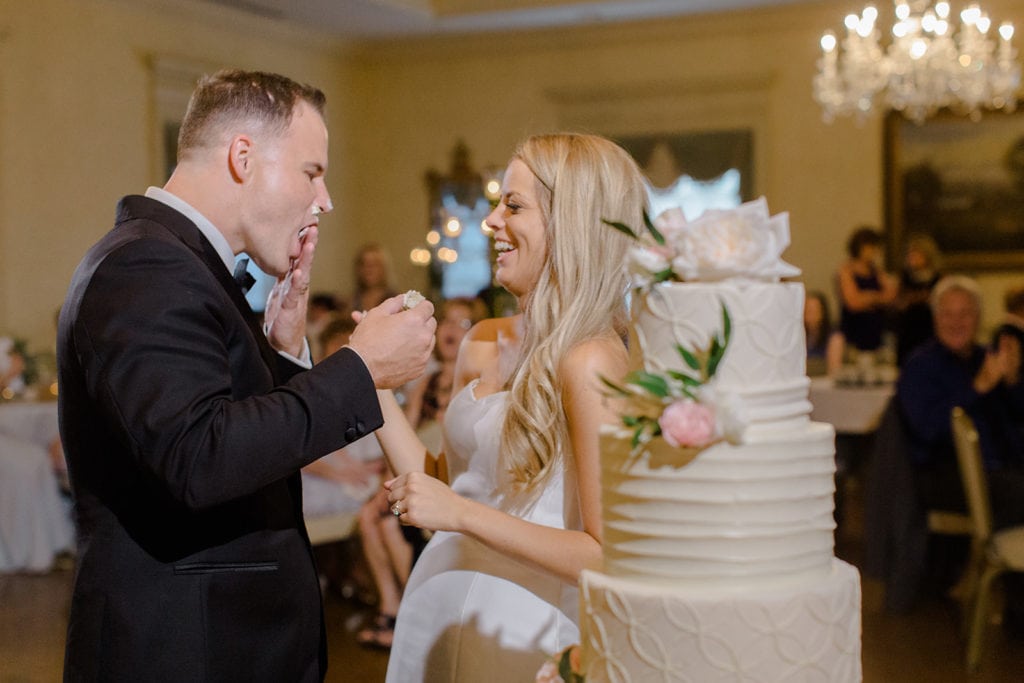 Bride and groom cutting their cake during Pittsburgh Field Club wedding