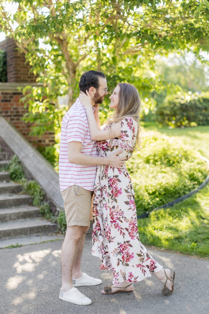 man and woman looking at each other laughing and embracing in mellon park: outdoor newborn session