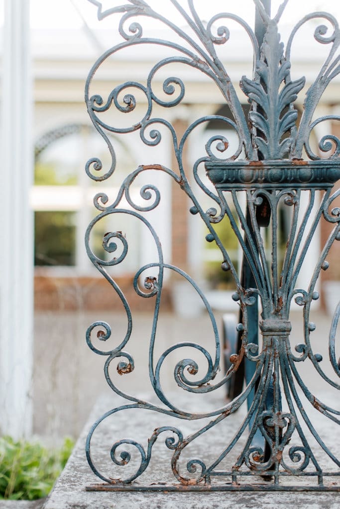 wrought iron decorative railing inside the walled english garden of mellon park: outdoor newborn session