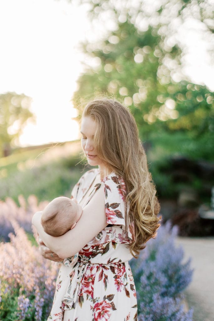 Newborn and mother walking through lavender in english garden: outdoor newborn session