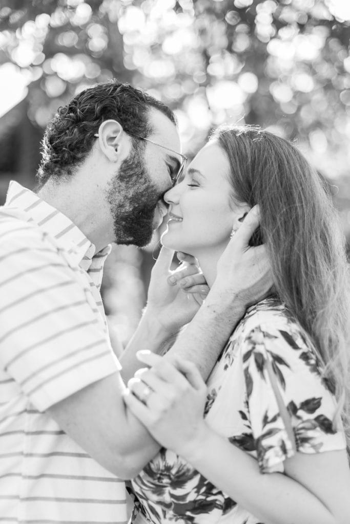 black and white image of couple kissing: outdoor newborn session