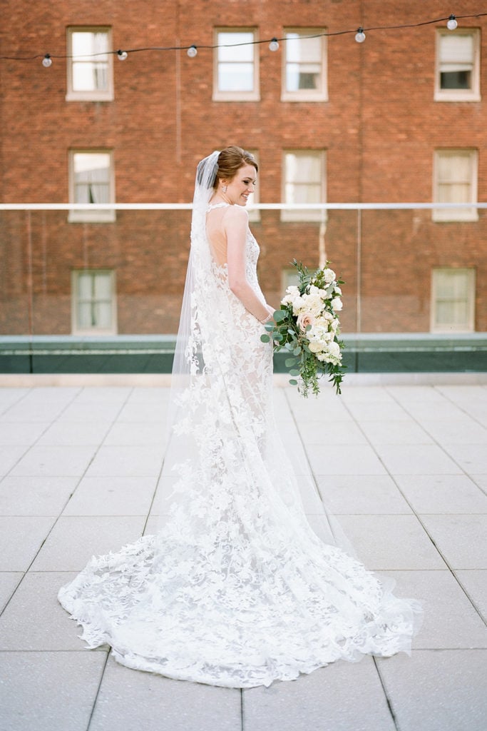 Bride holding white and greenery wedding bouquet