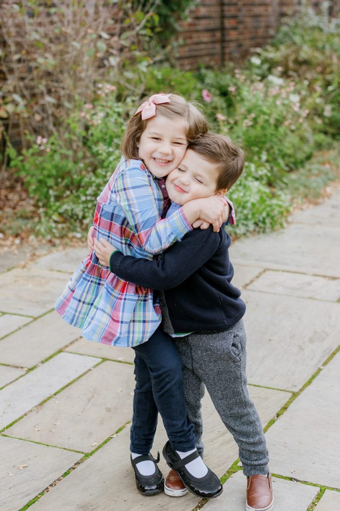 Brother and sister hugging during fall family photos