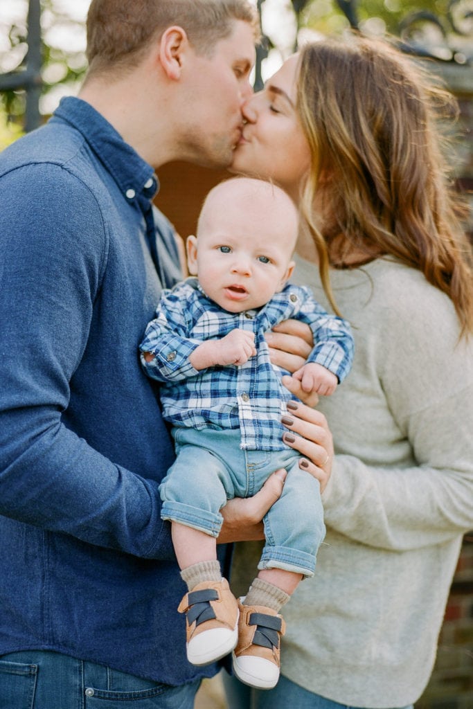 Baby dressed in blue plaid shirt for family photos