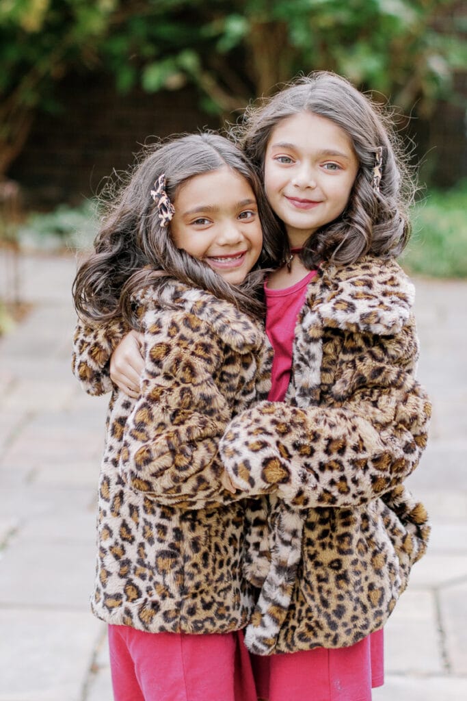 Sisters wearing matching leopard print coats