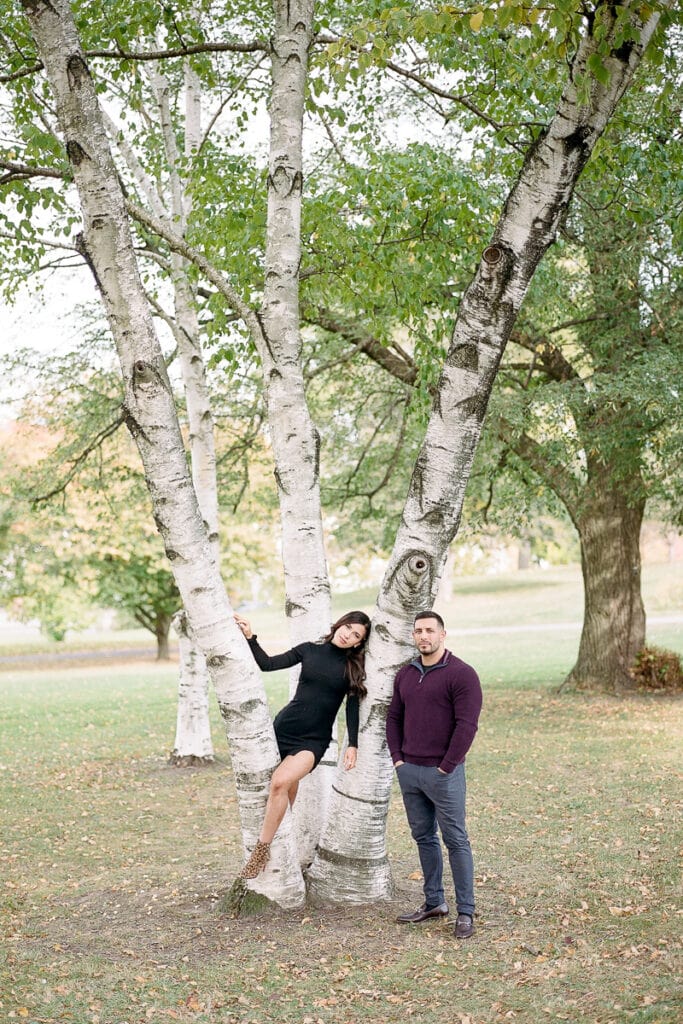 Couple posing in a tree in Mellon Park