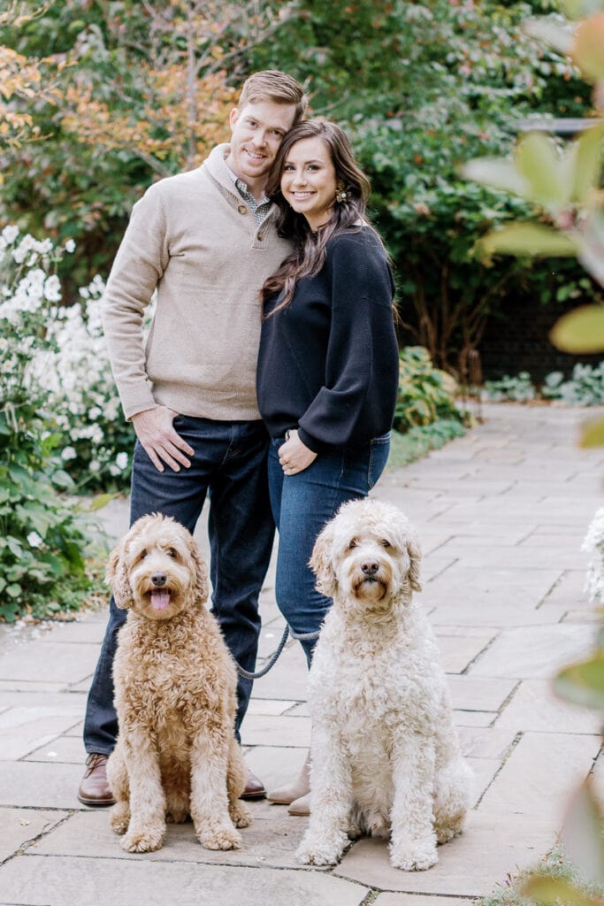 Husband and wife with their two doodle dogs