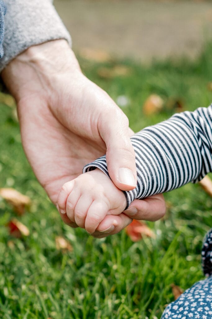 Father and daughter holding hands