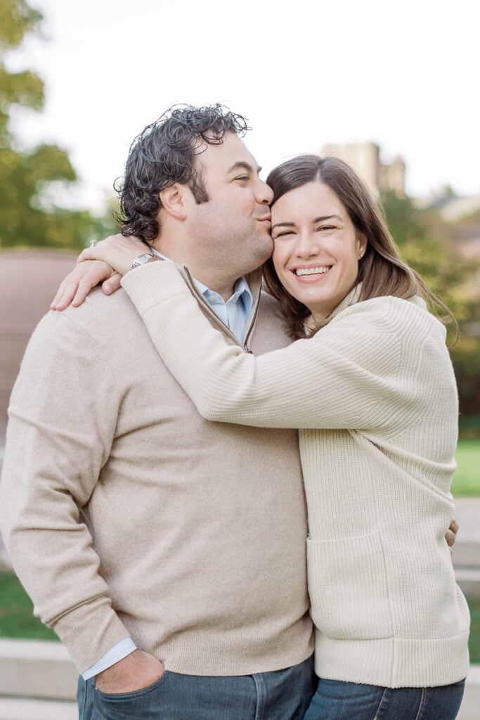 Wife hugging husband as he kisses her forehead mini sessions at Mellon Park