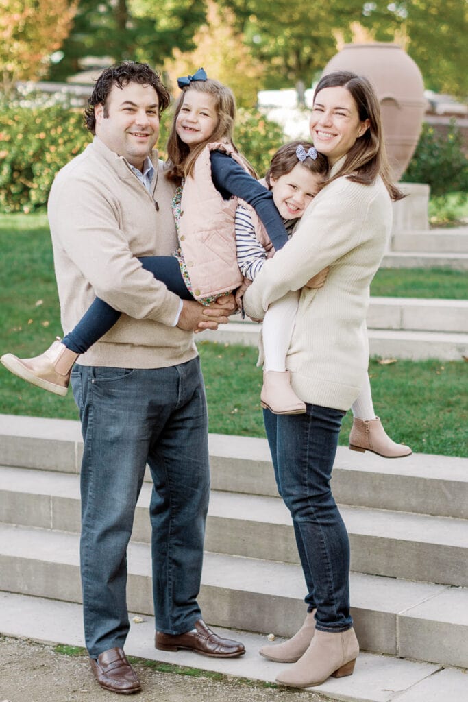 Mother and father holding their two daughters