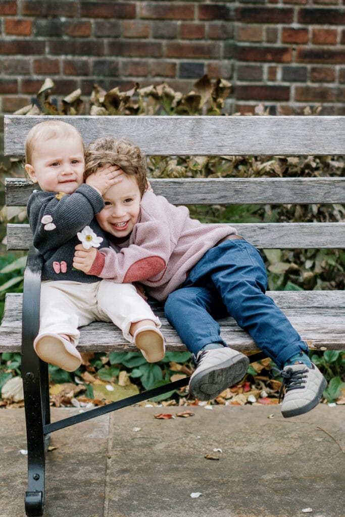 Two brothers hugging one another in Mellon Park