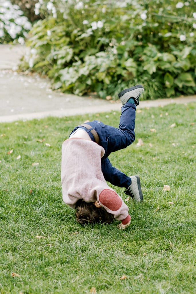 Little boy doing a somersault in Mellon Park