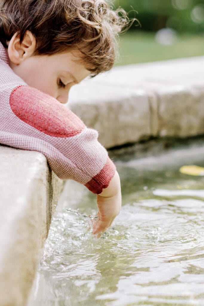 Little boy playing in Mellon Park fountain