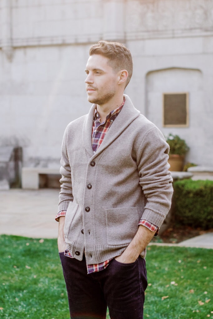 Man wearing a plaid shirt and button down cardigan