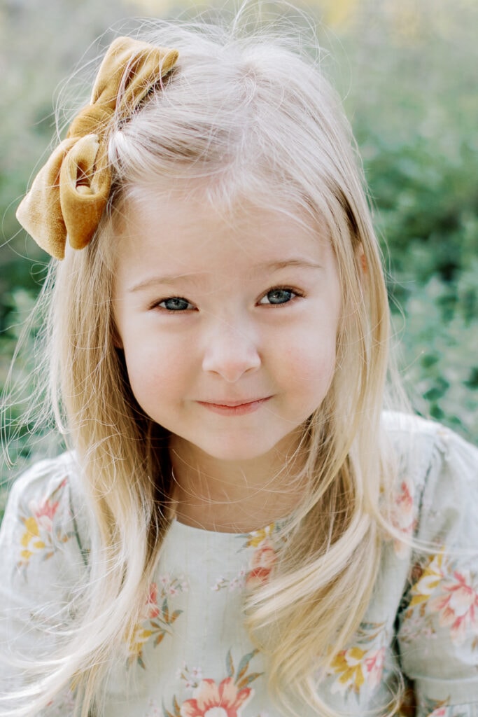 Little girl with a yellow bow in her hair mini sessions at Mellon Park