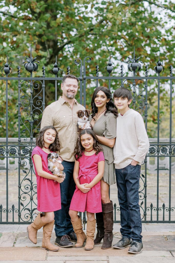 Family of five posing in front of Mellon Park gate