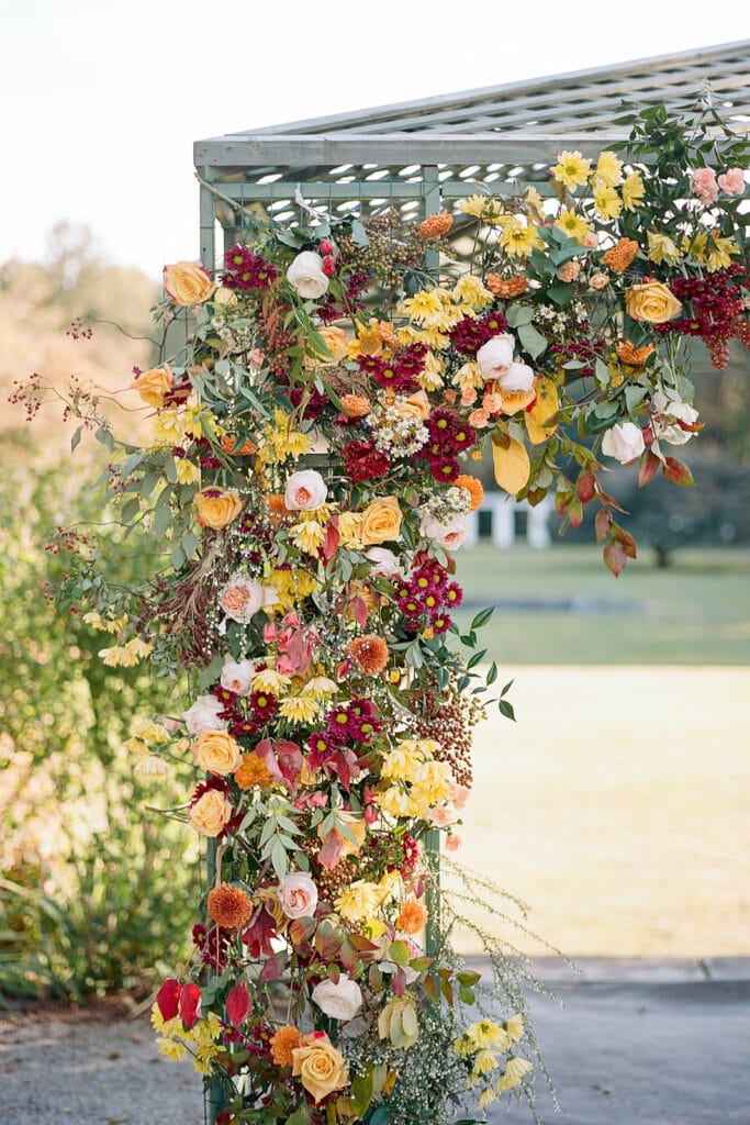 Warm colored wedding floral arch