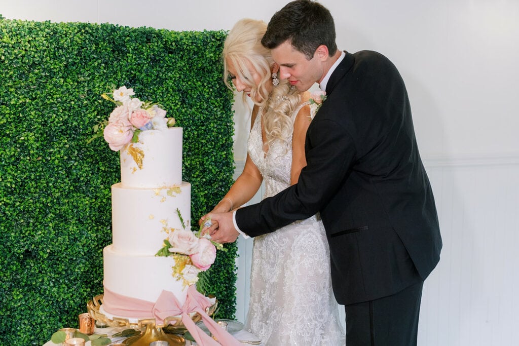 Bride and groom cutting wedding cake