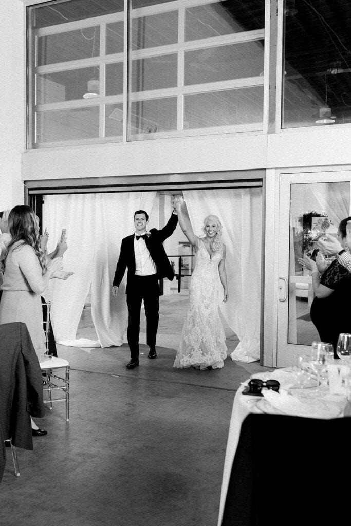 Bride and groom's grand entrance at Riverfront wedding