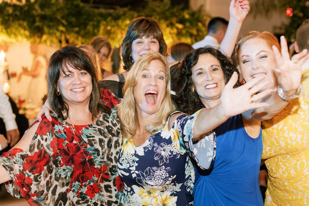 Family and friends dancing at luxe and romantic Riverfront wedding