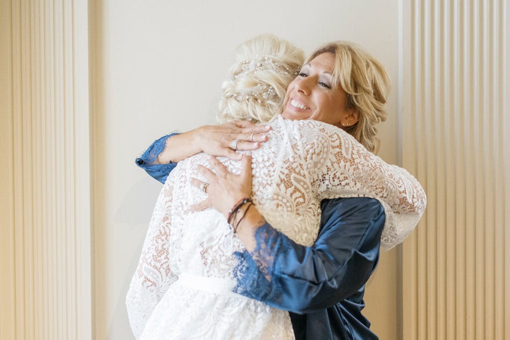 Bride hugging mother of the bride