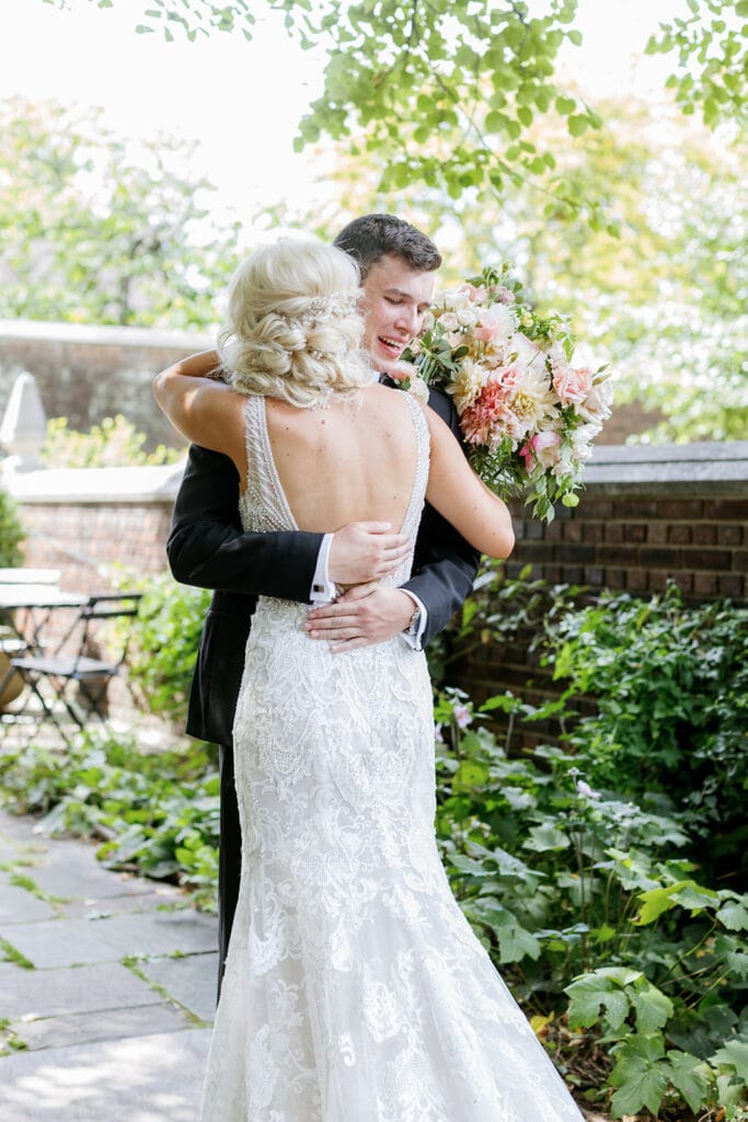 Bride and groom hugging during first look in Mellon Park