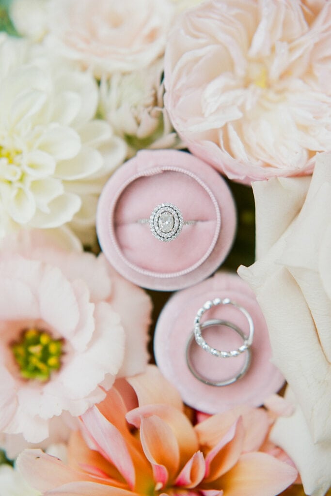 Wedding and engagement rings in circular pink ring box