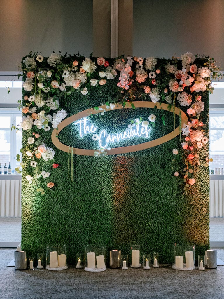 Boxwood flowers with neon wedding sign