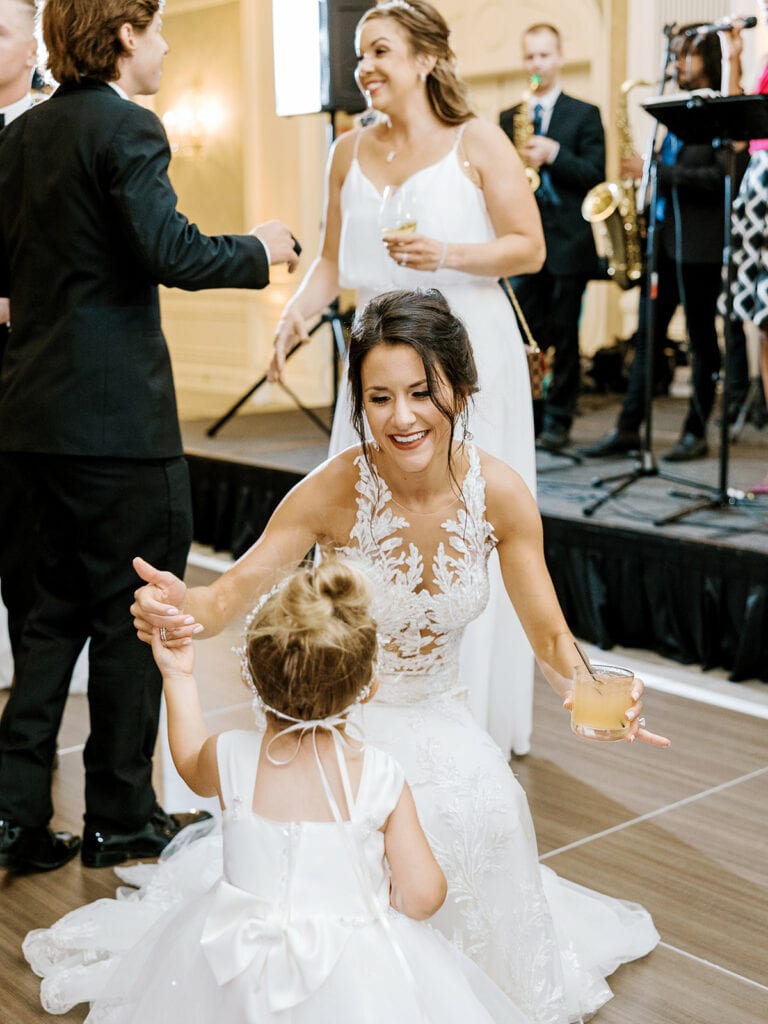 bride and flower girl dancing at nemacolin woodlands resort wedding