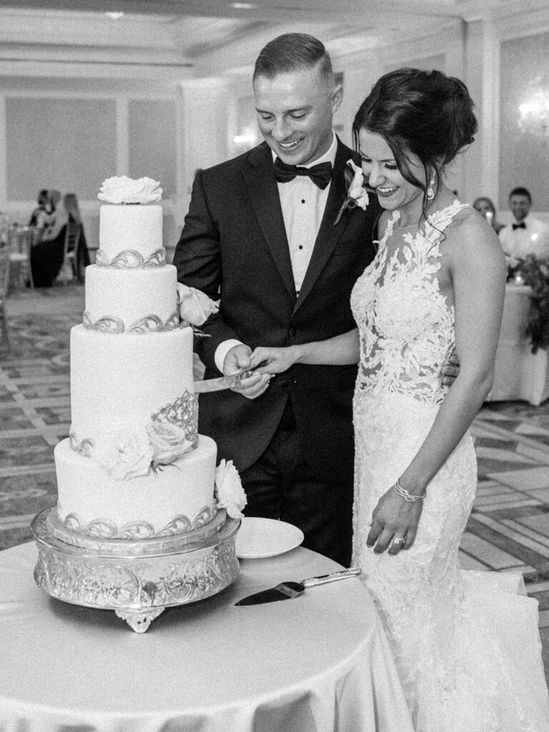 bride and groom cutting the cake at nemacolin woodlands resort wedding