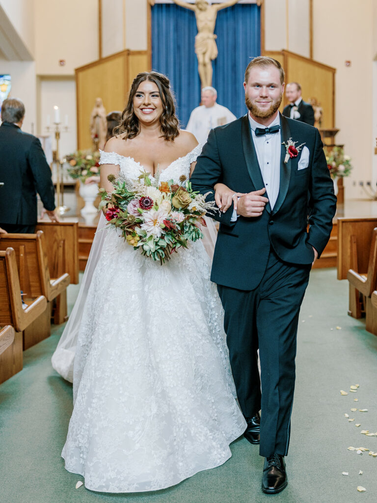 Photo of bride and groom walking back down the aisle at their Pittsburgh wedding ceremony.