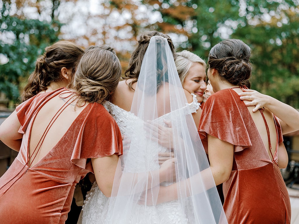 Photo of bride having a first look with her bridesmaids at a Pittsburgh wedding.