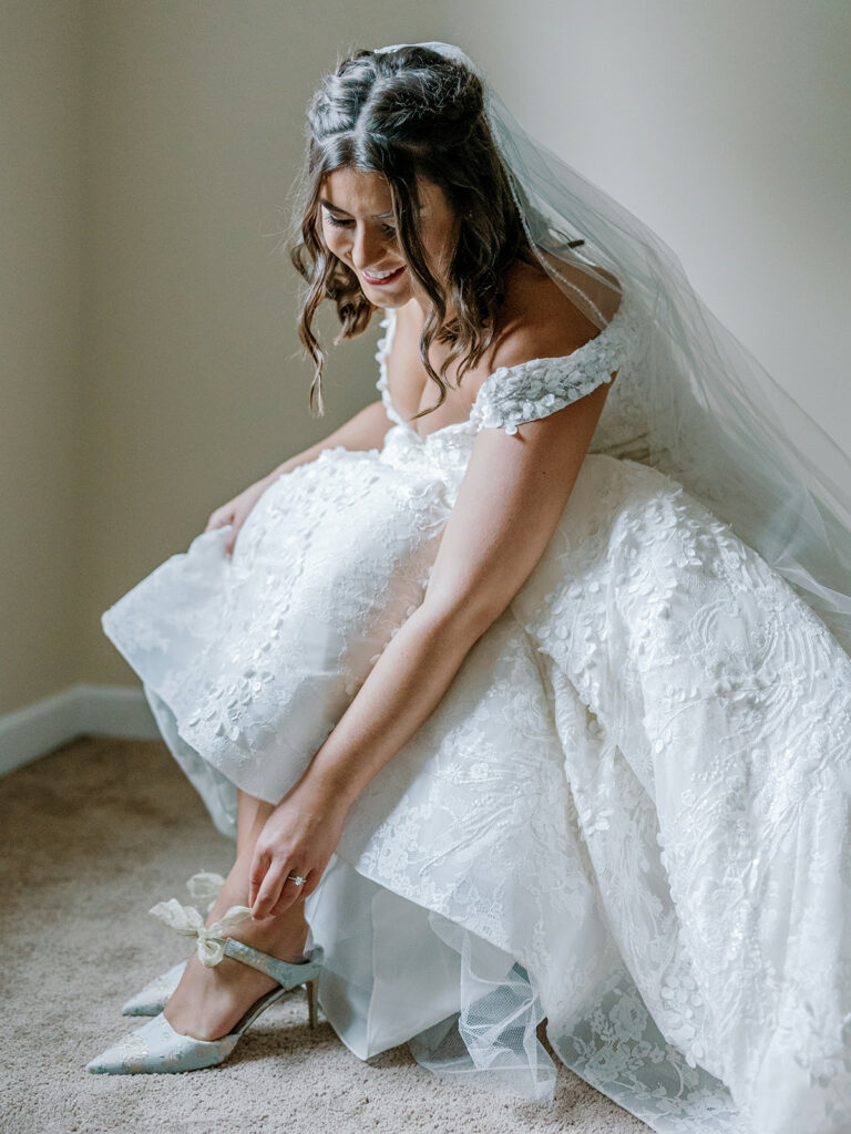 Photo of Pittsburgh bride putting her wedding shoes on.