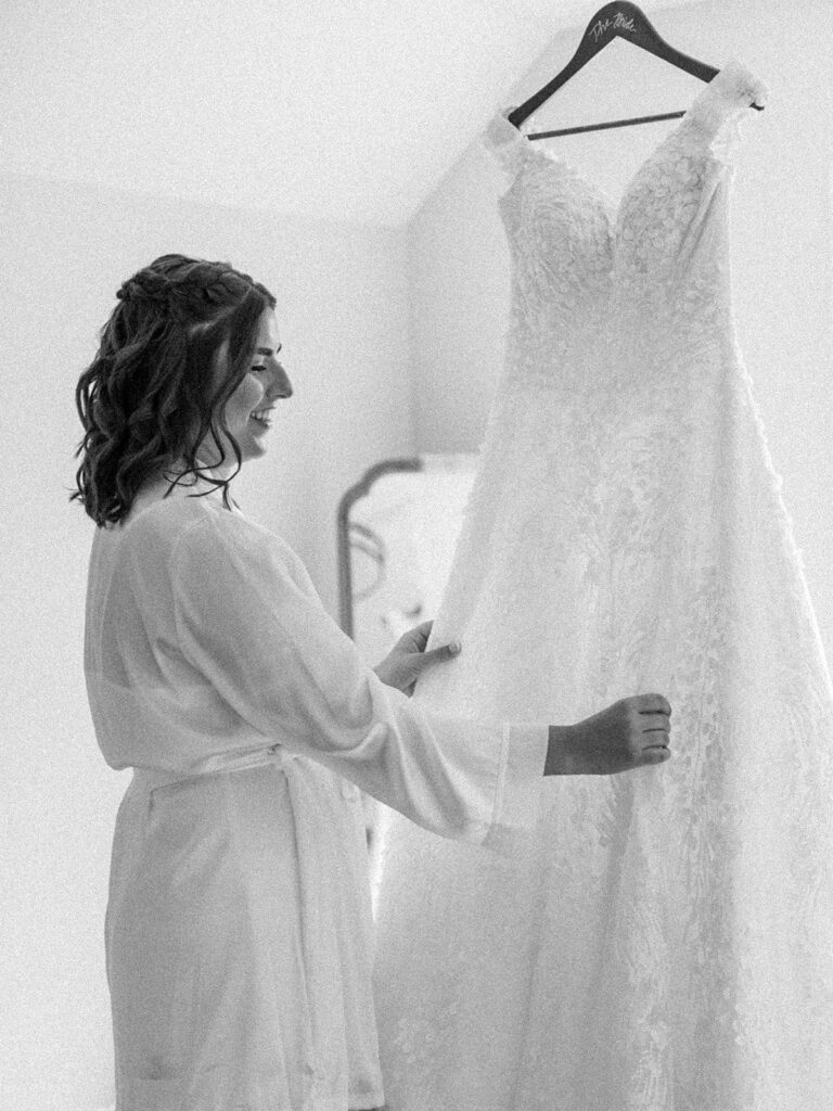 Photo of a Pittsburgh bride looking at her dress.