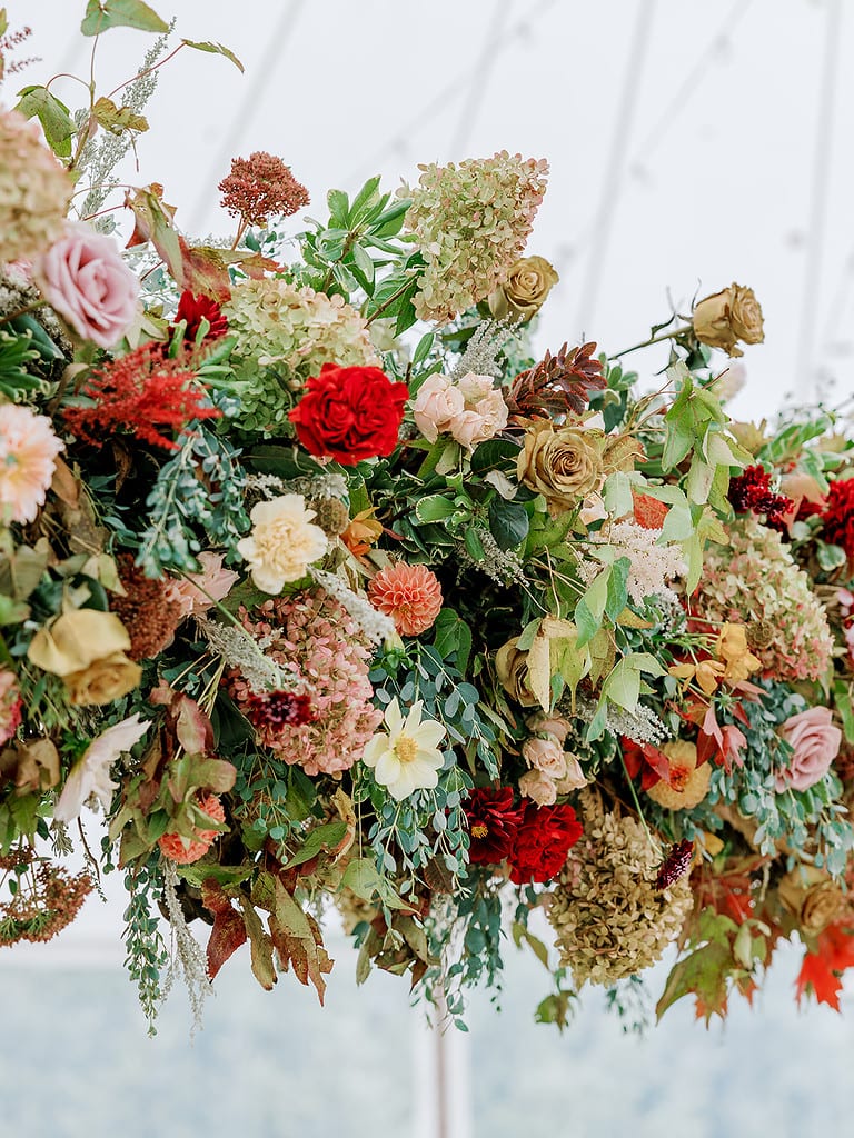 Photo of a floral installation at a luxury tent wedding reception.