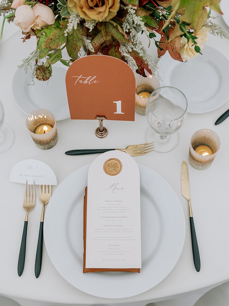 Photo of a place setting at a terracotta fall wedding.