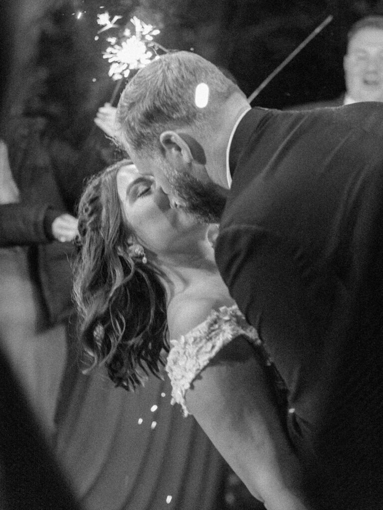 Photo of bride and groom in their sparkler exit at a fall outdoor wedding.