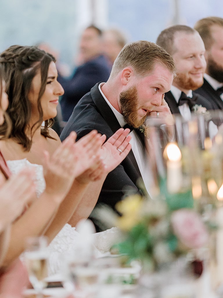 Photo of bride and groom sitting at their wedding reception in Pittsburgh.