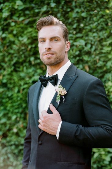 portrait of a groom on his wedding day wearing a tuxedo