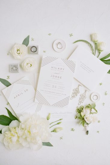 invitation suite flat lay photo with peonies and gold foil