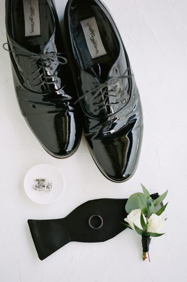 groom's details shoes cufflinks and bow tie and boutonnière