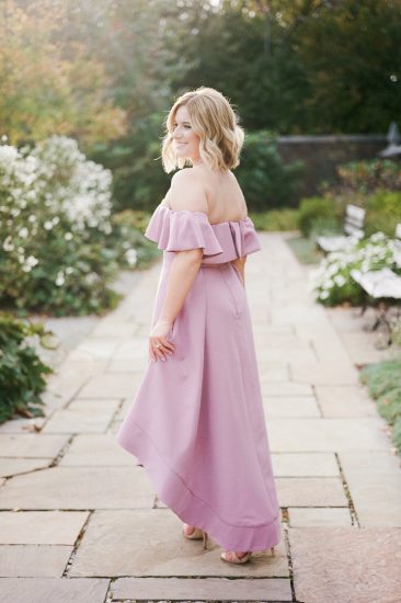 woman posing in a mauve off the shoulder dress