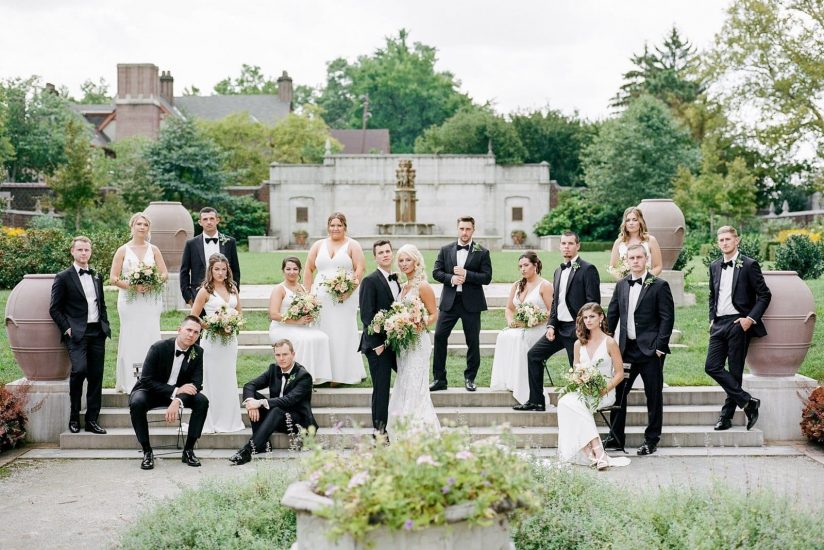bridal party posing in vogue vanity fair styled photo of the steps of mellon park
