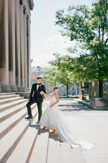 Bride and groom walking up the steps to the Mellon Institute Columns