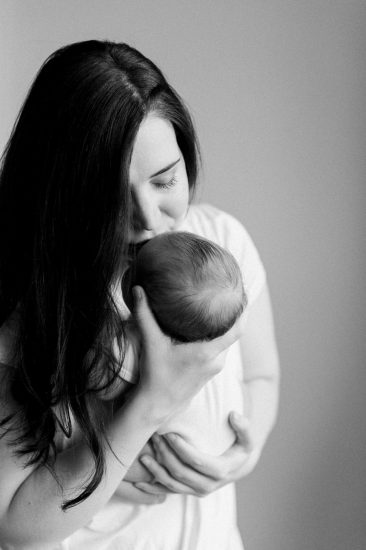 Black and white newborn photo of mom holding her newborn baby girl