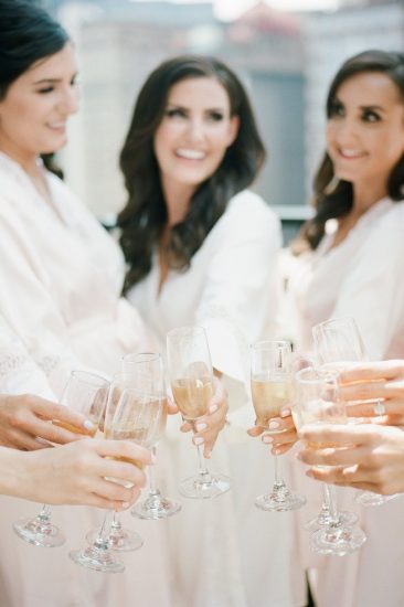 champagne toast with bridesmaids on rooftop of Renaissance hotel