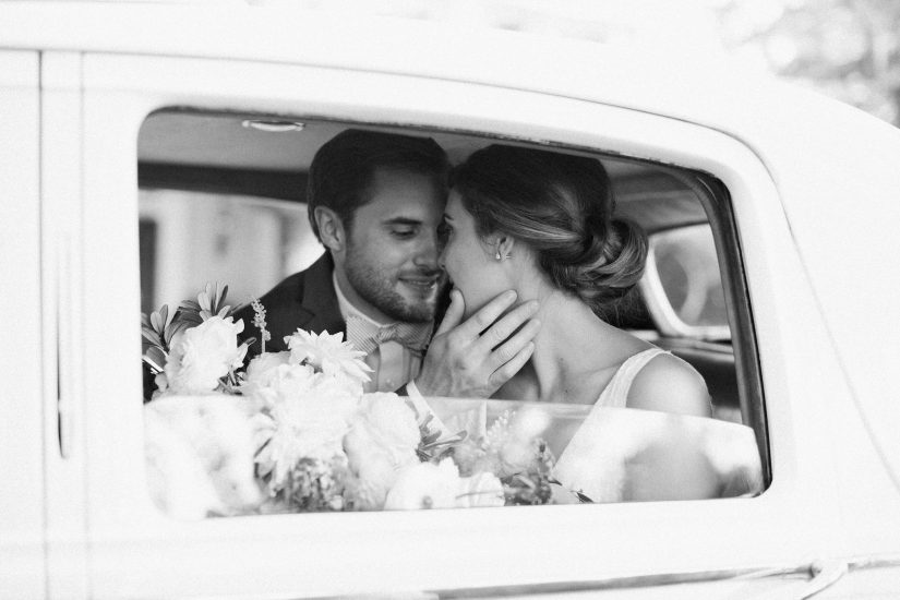 couple kissing in a rolls royce vintage car